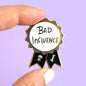 Bad Influence Lapel Pin held by fingers