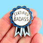 Hand holding Certified Badass Lapel Pin