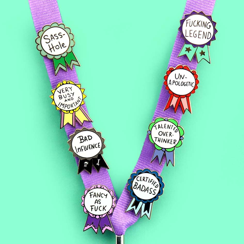 Fucking Legend Lapel Pin on a lanyard with other pins