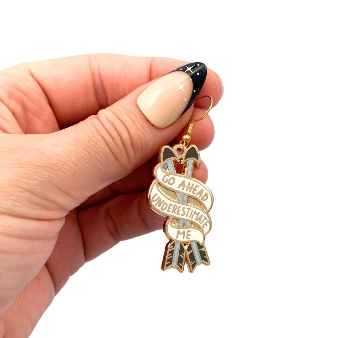 Go ahead underestimate me earring being held